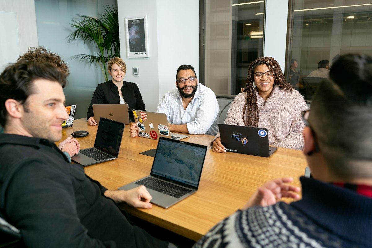 Web development team working together on laptops
