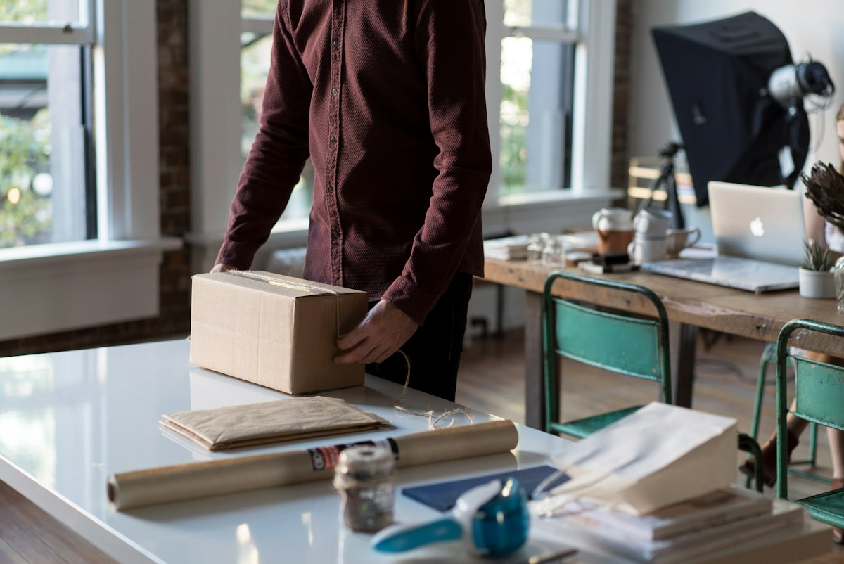 Small business owner packing an order from a WooCommerce online store